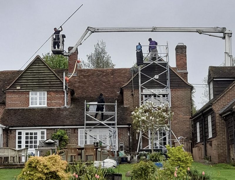The Moss Cleaners using cherry picker and scaffolding to clean roof safely and professionally in Kingswood, Gloucestershire